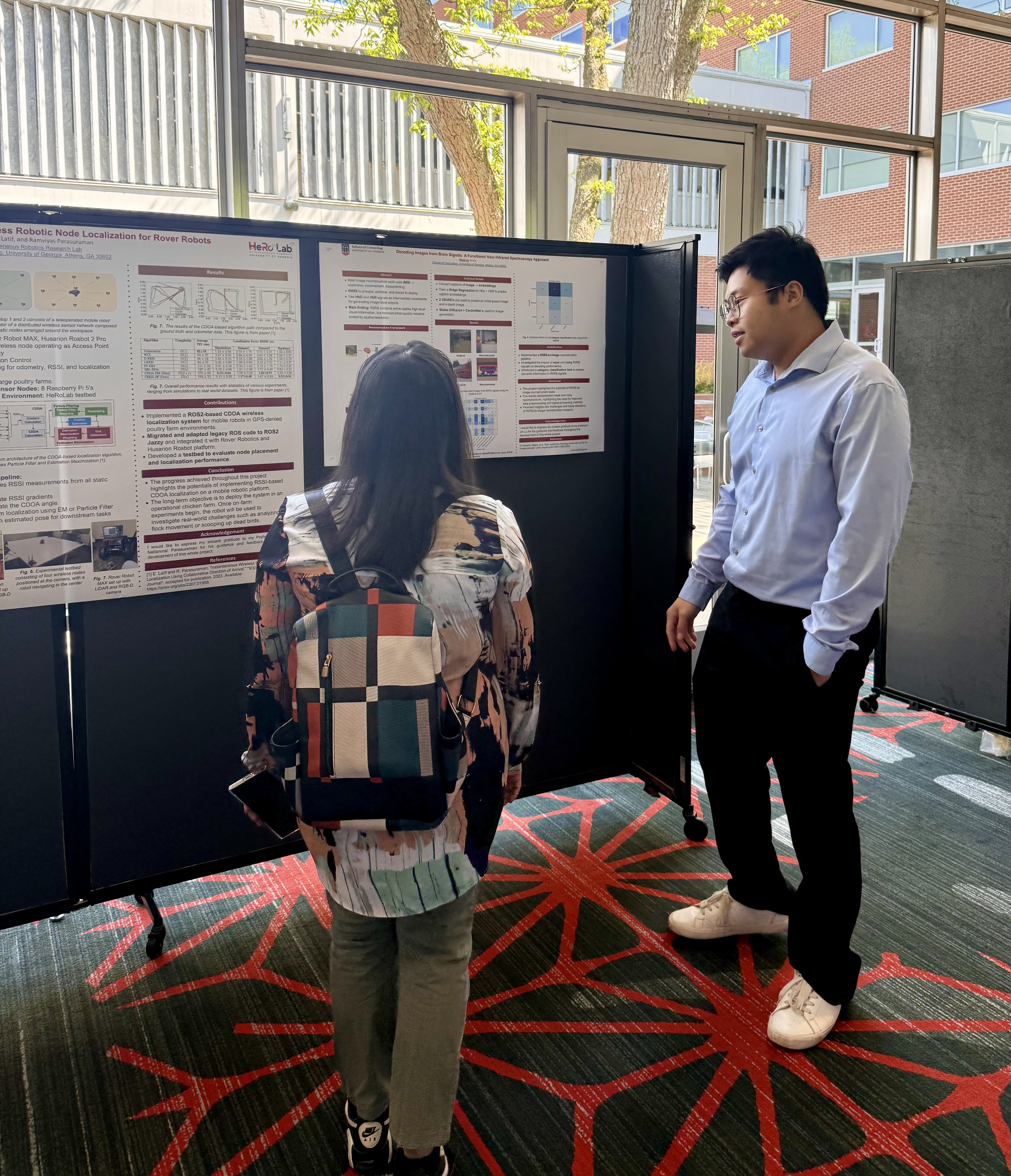 Two UGA SoC graduate students discussing a poster on 2026 SoC poster day