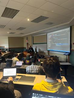 SoC students discussing code at UGAHacks9 event.