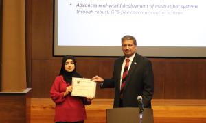 Aiman Munir accepts the Graduate Student Research Award presented by the SoC director Dr. Gagan Agrawal