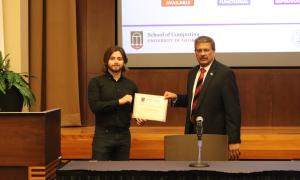 Nicolas Nino accepts the Graduate Student Research Award presented by the SoC director Dr. Gagan Agrawal