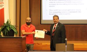 Aditya Shinde accepts the Graduate Student Research Award presented by the SoC director Dr. Gagan Agrawal